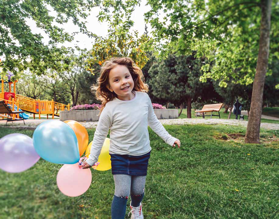 a photo of a girl running in a garden